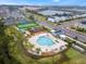 Overhead shot of a new community pool, playground, green space and green turf sports field at 4981 Windermere Ave, Kissimmee, FL 34746
