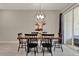 Elegant dining room with a rustic wood table, stylish lighting, and seamless access to the outdoor patio at 4981 Windermere Ave, Kissimmee, FL 34746