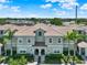 Charming two-story condo featuring a tile roof, gray exterior, and well-maintained landscaping with lovely palm trees at 4981 Windermere Ave, Kissimmee, FL 34746