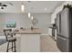 Open kitchen with stainless steel appliances, sleek counter tops, ample cabinet space, and modern lighting at 4981 Windermere Ave, Kissimmee, FL 34746