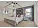 Stylish bedroom featuring a four poster bed, designer headboard, bedside tables, and plush carpeting at 4981 Windermere Ave, Kissimmee, FL 34746
