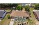 Aerial view of a home with a shingled roof, a well-kept yard, and surrounding mature trees at 505 Oak Dr, Tavares, FL 32778