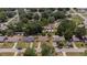 A neighborhood aerial view showcasing a mix of houses, streets, and lush greenery on a sunny day at 505 Oak Dr, Tavares, FL 32778