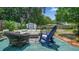 This spacious backyard features outdoor seating, a storage shed, and lush green foliage at 505 Oak Dr, Tavares, FL 32778