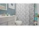 Bathroom features a white vanity, decorative shower curtain, and a clean, modern design at 505 Oak Dr, Tavares, FL 32778