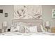 A bright bedroom features a decorative comforter, neutral headboard, and rose artwork at 505 Oak Dr, Tavares, FL 32778