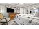 Bedroom featuring gray walls, a ceiling fan, and a wooden dresser with a mounted television at 505 Oak Dr, Tavares, FL 32778