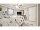 Bedroom boasting a ceiling fan, gray walls, and a comfortable bed with a decorative comforter at 505 Oak Dr, Tavares, FL 32778