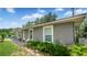 Side view of a cozy single-story home with well-maintained landscaping, and a welcoming front porch at 505 Oak Dr, Tavares, FL 32778