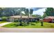 Charming single-story home with well-maintained landscaping and inviting curb appeal on a sunny day at 505 Oak Dr, Tavares, FL 32778