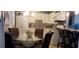 Bright kitchen with white cabinets, stainless appliances, decorative backsplash, and adjacent dining area at 505 Oak Dr, Tavares, FL 32778