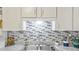 Close up of the kitchen sink featuring a modern faucet and decorative backsplash at 505 Oak Dr, Tavares, FL 32778