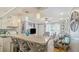 Open living space featuring bar stool seating at a kitchen counter flowing to a well lit, furnished living room at 505 Oak Dr, Tavares, FL 32778