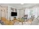 Cozy living room featuring hard wood floors, a large screen television, and comfortable seating at 505 Oak Dr, Tavares, FL 32778