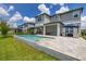 Backyard patio with covered outdoor dining and lounge area, plus a backyard pool at 5133 Citrus Leaf Blvd, Winter Garden, FL 34787