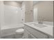 Bathroom featuring a bathtub with white tiled walls, vanity, and a toilet at 5133 Citrus Leaf Blvd, Winter Garden, FL 34787