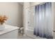 Bathroom features shower and tub combo, white tile surround, and a blue pattern curtain at 5133 Citrus Leaf Blvd, Winter Garden, FL 34787
