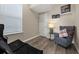 Cozy bedroom with a soft armchair, side table and a decor shelf at 5133 Citrus Leaf Blvd, Winter Garden, FL 34787