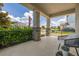 Inviting covered front porch with stone pillars, decorative railing, outdoor seating, and views of the neighborhood at 5133 Citrus Leaf Blvd, Winter Garden, FL 34787