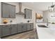 Well-lit kitchen featuring grey cabinetry, quartz countertops, subway tile backsplash, and stainless steel appliances at 5133 Citrus Leaf Blvd, Winter Garden, FL 34787