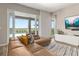Bright living room featuring a comfortable leather sofa, large sliding glass doors, and a view of the pool at 5133 Citrus Leaf Blvd, Winter Garden, FL 34787