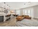 Open-concept living room with modern decor, a spacious seating area, and seamless connection to the dining and kitchen at 5133 Citrus Leaf Blvd, Winter Garden, FL 34787
