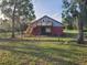 Two story barn with stairs and small balcony area in fenced in yard at 600 Lake Butler Ave, Osteen, FL 32764