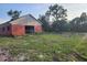 Red barn with partial open front, showing a spacious interior, sitting on a grassy lot at 600 Lake Butler Ave, Osteen, FL 32764