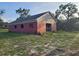 Exterior view of a red barn with an open side, set on a grassy lot at 600 Lake Butler Ave, Osteen, FL 32764