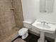 Bathroom featuring a standalone shower, pedestal sink and neutral color palette at 600 Lake Butler Ave, Osteen, FL 32764
