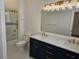 Bathroom with double sinks, marble countertops, navy blue cabinets, and shower at 600 Lake Butler Ave, Osteen, FL 32764