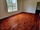Spacious bedroom with hardwood floors and a large window offering natural light at 600 Lake Butler Ave, Osteen, FL 32764