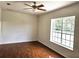 Bedroom with hardwood floors, ceiling fan and large window providing natural light at 600 Lake Butler Ave, Osteen, FL 32764