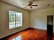 Bedroom with hardwood floors, ceiling fan and large window offering a view at 600 Lake Butler Ave, Osteen, FL 32764