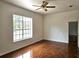 Bright, airy bedroom with hardwood floors, ceiling fan and large window with natural light at 600 Lake Butler Ave, Osteen, FL 32764