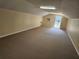 Spacious bonus room with neutral carpet, side door, and window AC unit at 600 Lake Butler Ave, Osteen, FL 32764