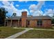Charming brick home with a well-maintained lawn, blue skies and a prominent brick chimney at 600 Lake Butler Ave, Osteen, FL 32764