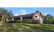 Charming home featuring a brick facade, covered porch, and a spacious front lawn at 600 Lake Butler Ave, Osteen, FL 32764