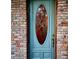 Stylish front door with a decorative window insert, surrounded by a classic brick exterior at 600 Lake Butler Ave, Osteen, FL 32764