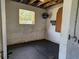 An interior room with painted cinderblock walls, a window, and a metal fan at 600 Lake Butler Ave, Osteen, FL 32764
