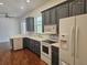 Kitchen featuring white refrigerator, stainless appliances, and wooden cabinets at 600 Lake Butler Ave, Osteen, FL 32764
