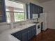 Bright kitchen featuring stainless appliances, white countertops and wooden cabinets at 600 Lake Butler Ave, Osteen, FL 32764