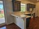 Well-lit kitchen featuring abundant counter space, tiled countertops and floors, and wooden cabinets at 600 Lake Butler Ave, Osteen, FL 32764