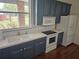 Bright kitchen featuring stainless appliances, white countertops and wooden cabinets at 600 Lake Butler Ave, Osteen, FL 32764