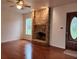 Spacious living room with a brick fireplace, hardwood floors, and natural light at 600 Lake Butler Ave, Osteen, FL 32764