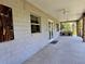 Covered patio with ceiling fans, brick columns, and an outdoor brick kitchen area, perfect for entertaining at 600 Lake Butler Ave, Osteen, FL 32764