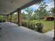 Spacious covered porch featuring brick columns and an outdoor cooking area with views of the lush surrounding landscape at 600 Lake Butler Ave, Osteen, FL 32764