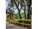 Beautiful yard with mature trees, a wooden fence, and charming landscape elements at 600 Lake Butler Ave, Osteen, FL 32764
