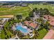 Enjoy this aerial view of the community pool, lush landscaping, and other amenities at 661 Drop Shot Dr, Davenport, FL 33896