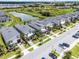 An aerial view of the townhome community with a pond and beautiful landscaping at 661 Drop Shot Dr, Davenport, FL 33896